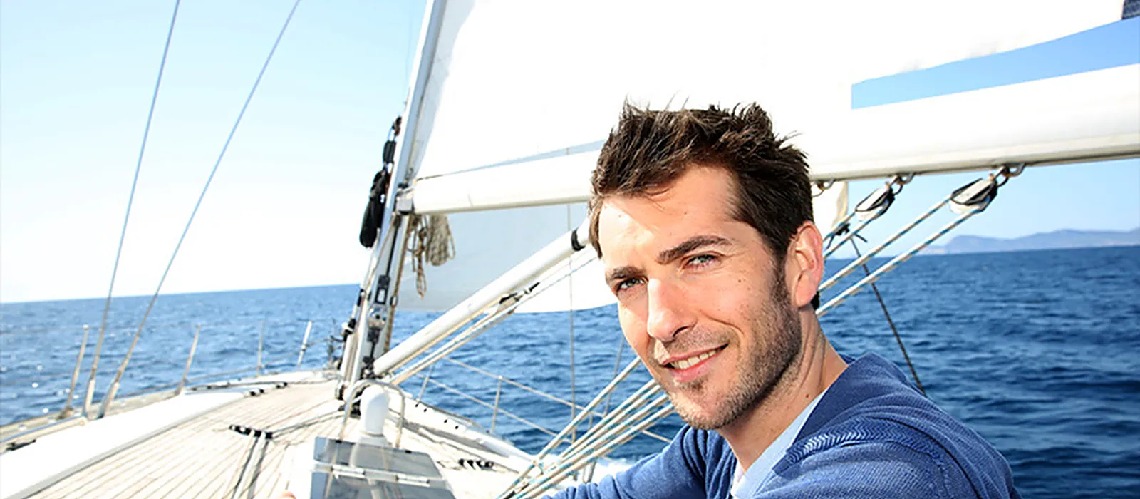 Dirigeant a la barre d'un voilier en mer, image du cap et de l'accompagnement de proximite